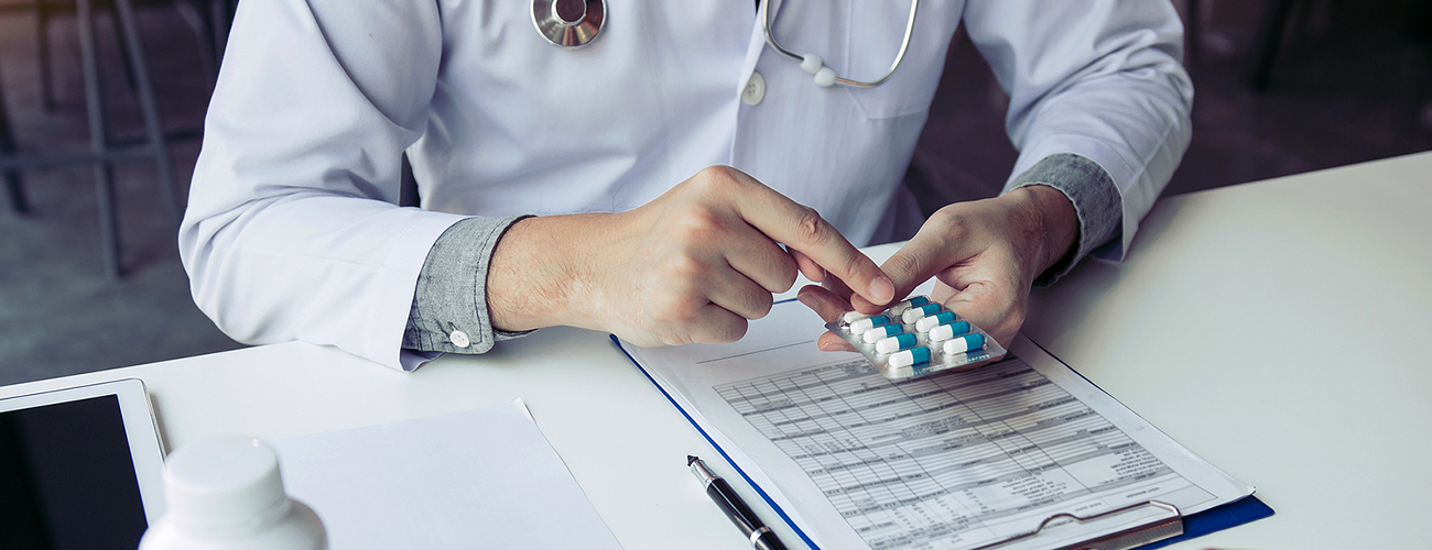 doctor examining pill strip