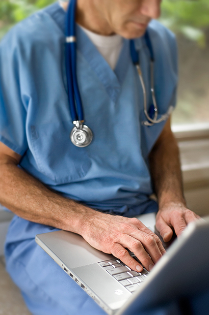 Image of doctor working with a laptop